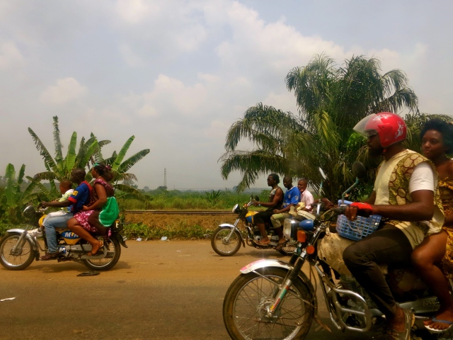 Motorcycle taxis speed toward Douala, Cameroon's major port and commercial center